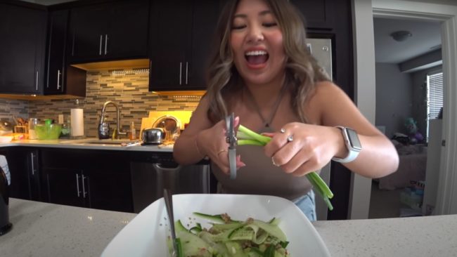 Image of a smiling woman preparing a meal