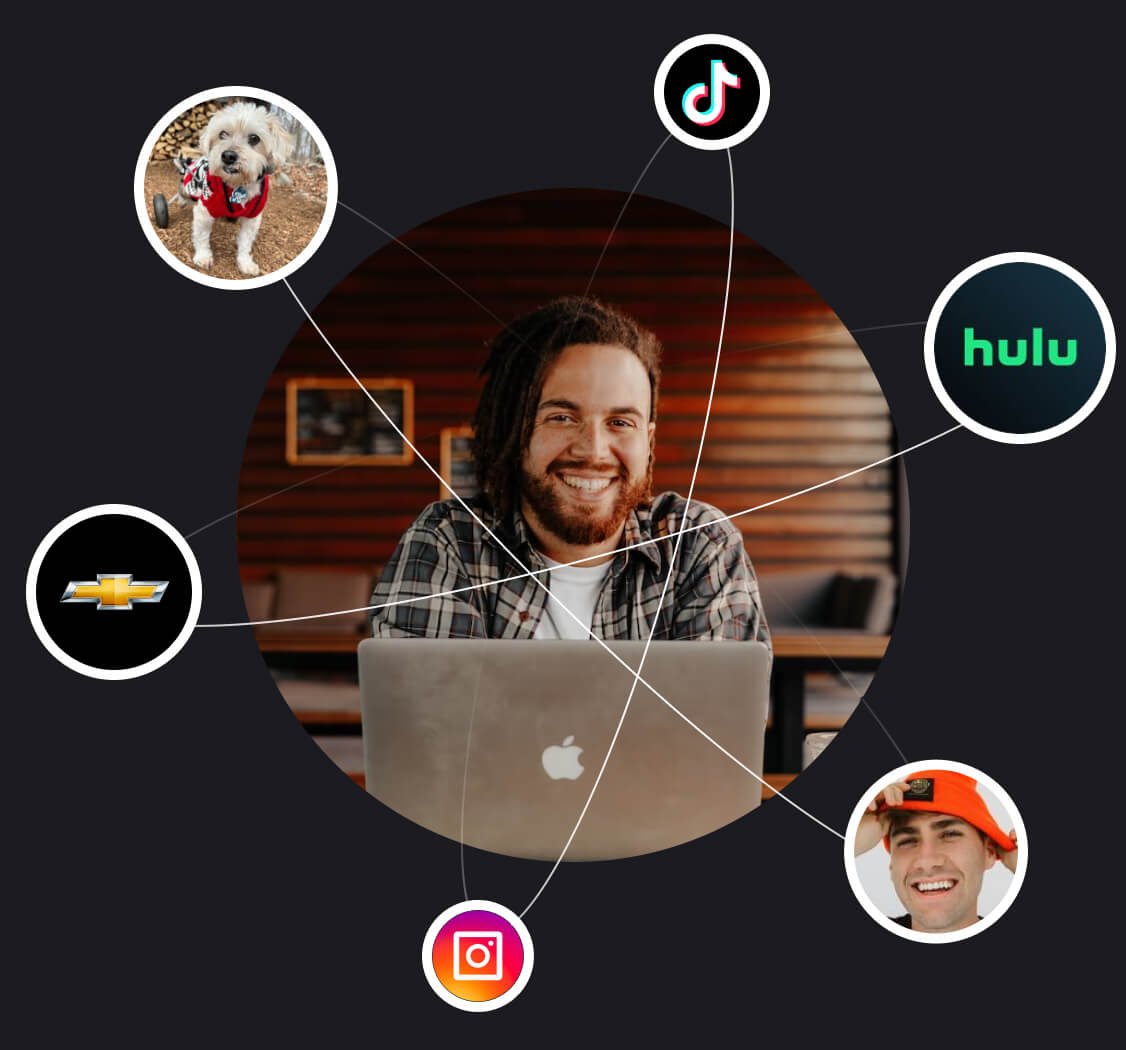 smiling man on Apple computer in ecosystem of potential social influencer and brand partnerships