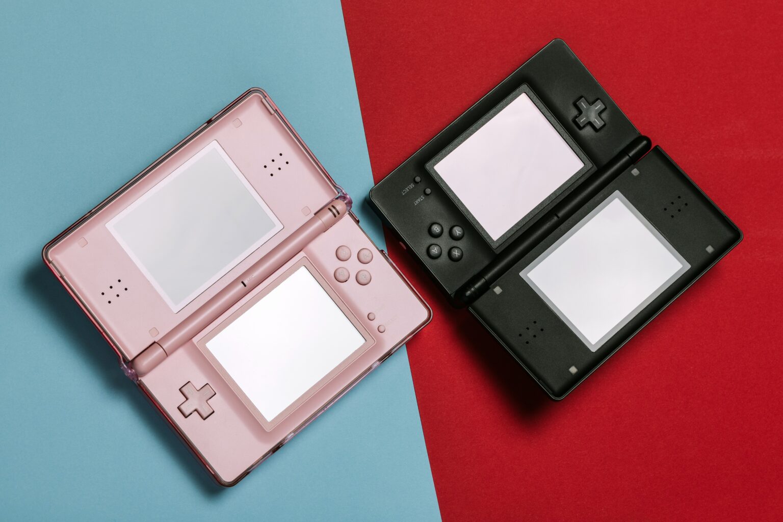 two Nintendo DS placed next to each other on a blue and red background