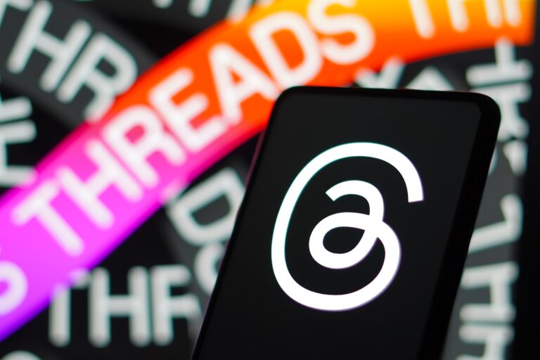 Threads brand strategy: Threads logo is displayed on a smartphone screen. Threads is the new social network and messaging app from Meta Platforms