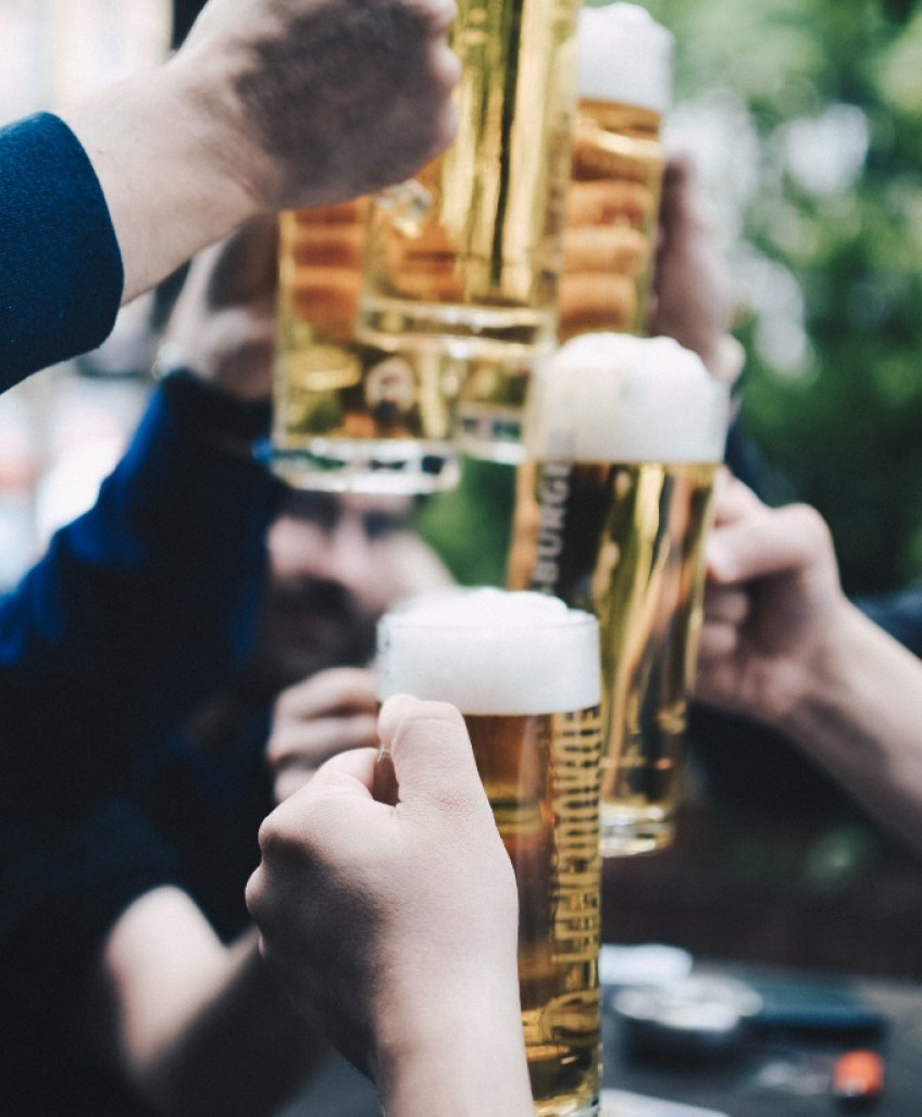 Alcohol in glass toasting with group