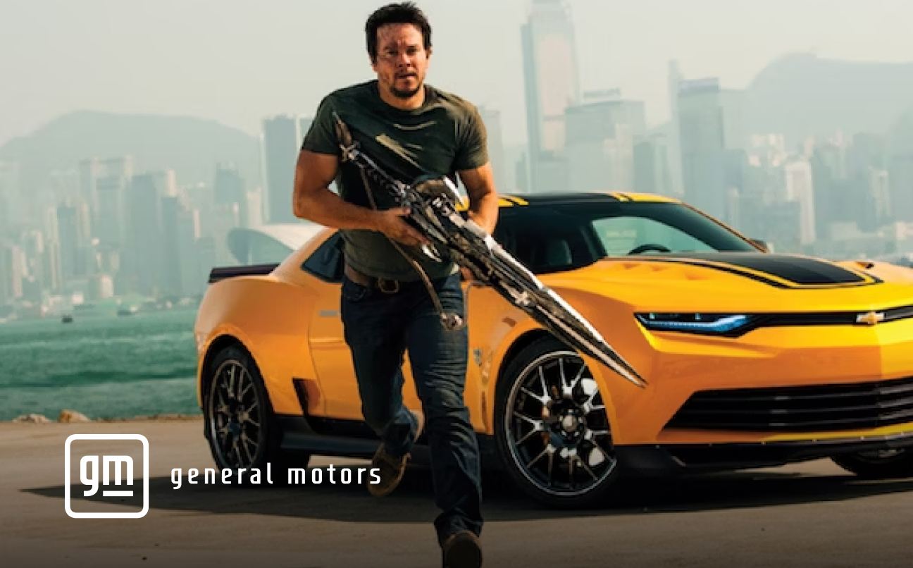 guy holding gun with a yellow car behind