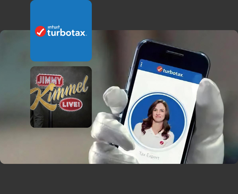 Holding a smartphone showing the TurboTax app