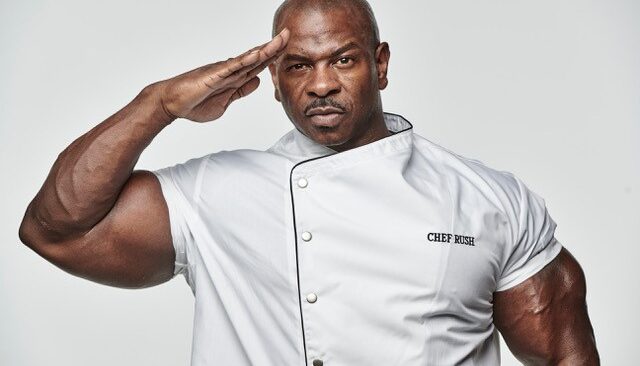 Chef Andre Rush saluting in chef's whites